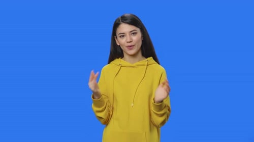 Young Woman Talking on a Blue Background