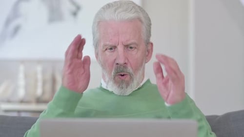 Close Up of Old Man Having Loss on Laptop