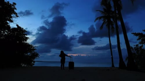 Beautiful smiling lady relaxing spending quality time at the beach on summer white sand and blue 4K