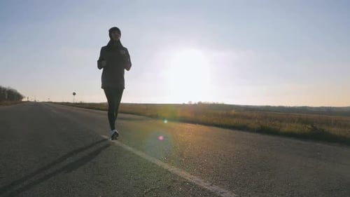 Young Fitness Woman Runner Athlete Running at Road