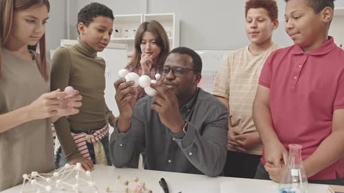 Teacher Explains Molecule Model to Eager Students
