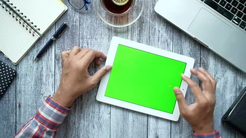 Flat Composition of Young Man Suing Digital Tablet on Office Desk
