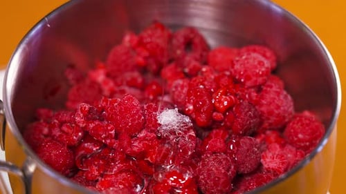 Glazed Raspberries in a Metal Bowl, Close Up