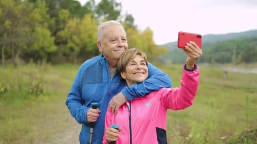 Happy Senior Couple Having Fun Taking a Selfie Hiking in the Woods Healthy Elderly and Technology