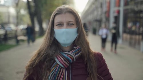 Woman Wearing Face Mask To Protect Against Covid-19 Virus Walking City