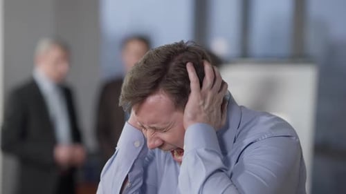 Closeup Portrait of Angry Furious Caucasian Man Screaming in Office Indoors