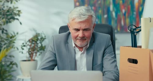 Senior Man Working at Computer in Office