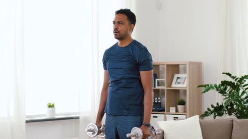 Man Doing Dumbbell Lateral Raises at Home