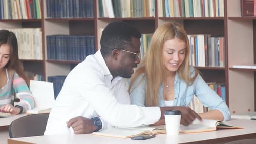 Multiracial Group of University Students Visiting Library at the Session Period