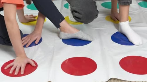 Children Playing a Game on a Colorful Mat
