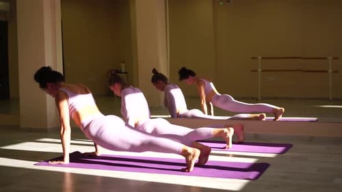 Woman Practices Yoga in Sunny Studio
