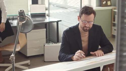 Couple of Design Engineers Coworking in Office