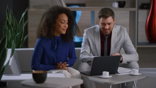 Multiracial Colleagues Video Calling Leading Presentation Showing Graph in Cafe