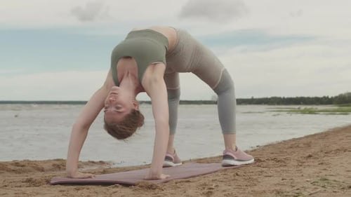 Young Woman in Bridge Pose during Yoga Practice
