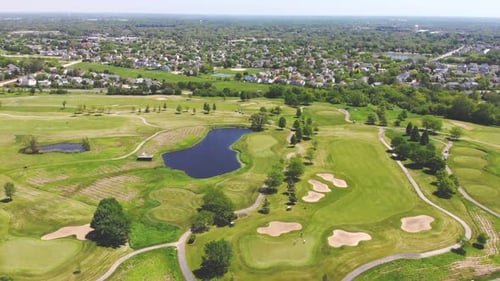 Aerial View From the Top n of the Golf Course. People and Cars on a Golf Course From a Height.