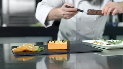 Chef Plating Dessert with Precision in Professional Kitchen