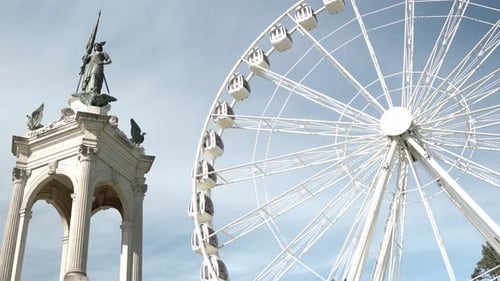Ferris wheel in the park and a statue