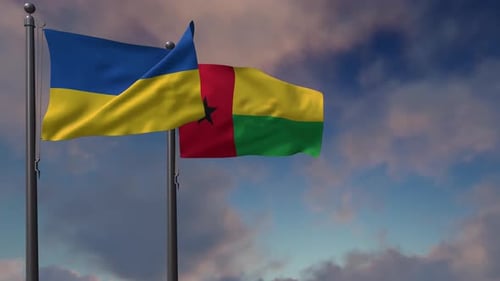 Waving Flags of Ukraine and Guinea-Bissau under Cloudy Sky