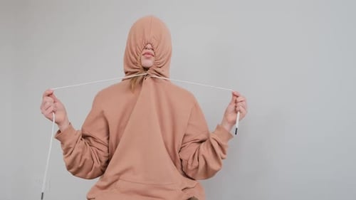 Sad Teenage Girl with Large Birthmark on Face Hides in Hood