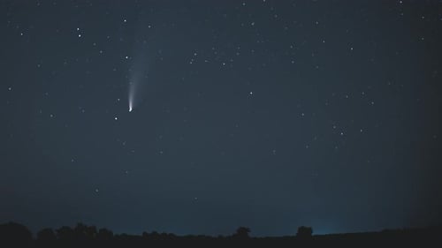 Comet Soaring Across the Starry Night Sky
