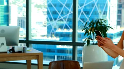 Stylish Woman Using Smartphone in Modern Office