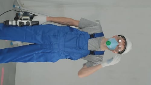 Man Drilling into Wall with Large Drill