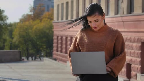 Young Woman Outdoors Working on Laptop
