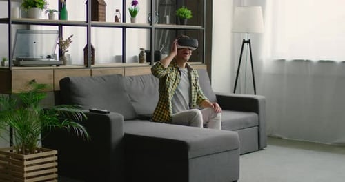 Man Wearing VR Headset on Couch