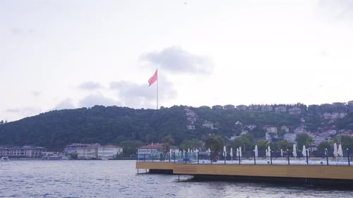 Istanbul Waterfront Scene with Turkish Flags