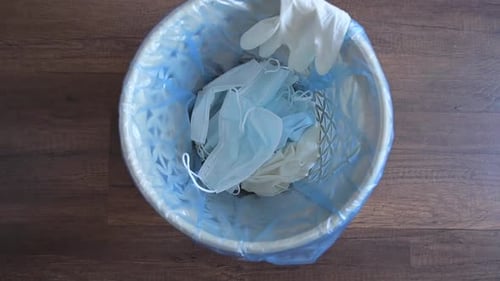 Used Masks and Gloves Discarded in Waste Bin