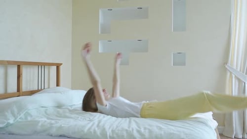 Woman Falling on Bed. Slow Motion
