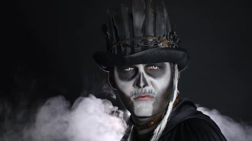 Creepy Man with Skeleton Makeup Appearing From Darkness When Light Falls on Him, Making Faces