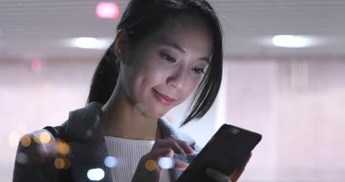 Woman use of mobile phone in city