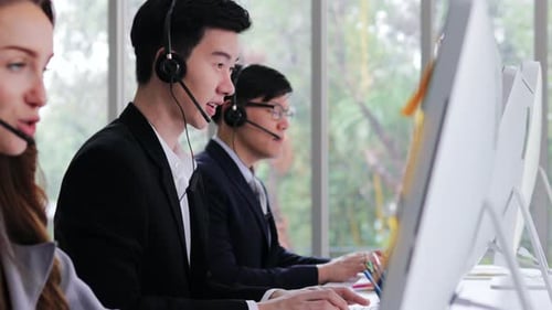 Call center man support specialist talking on a headset with customer