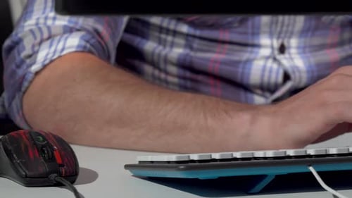 Man Typing at Keyboard in Office Workplace
