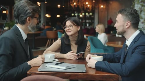 Business Men Talking Discussing Deal with Interpreter Then Shaking Hands in Restaurant