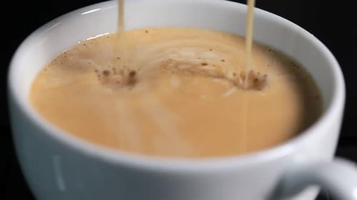 Espresso Poured Into White Coffee Mug Close Up