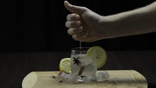 Squeezing Lemon Juice Into a Glass. Fornt View