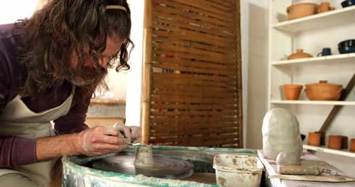 Artist Sculpts Clay on Pottery Wheel