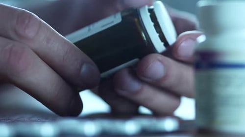 Hands Opening Prescription Medicine Bottle Close Up