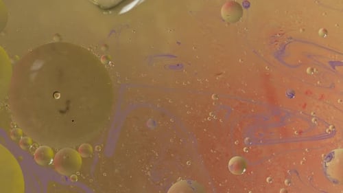 Abstract Spheres and Swirls in Light Orange Liquid