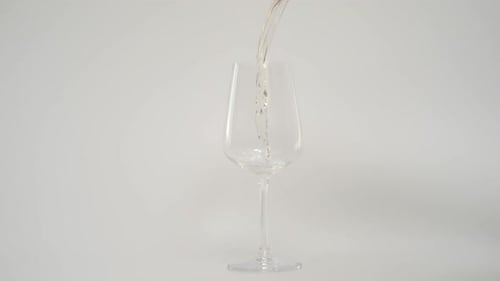 Wine Pouring into Glass on White Background