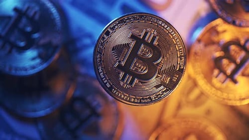 Close-up of Shiny Bitcoin Coin on Banknotes