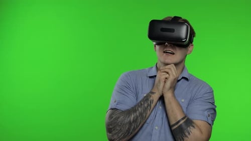 Man Using VR Headset Reacts to Virtual Reality