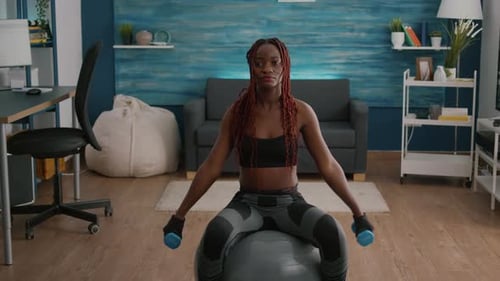Woman Doing Shoulder Lifts on Yoga Ball