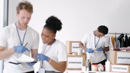 Volunteers Sorting and Packing Donations Indoors