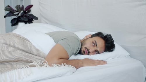 Man Wakes Up and Uses Mobile Phone in Bed
