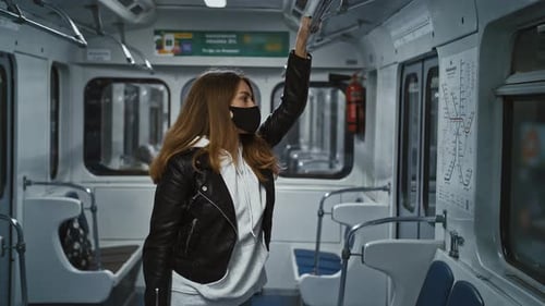 Woman Riding Empty Subway Car Wearing Face Mask