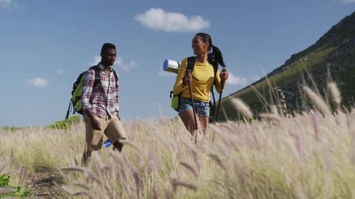 Couple Hiking Together in Mountainous Grassy Terrain
