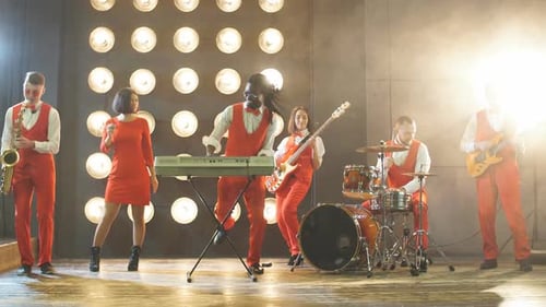 Energetic Band Plays on Lighted Stage